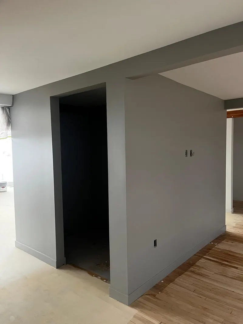 Drywall finished smooth and painted gray around a new room and doorway