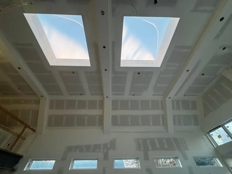 Vaulted ceiling with two skylights, drywall hung, taped and mudded